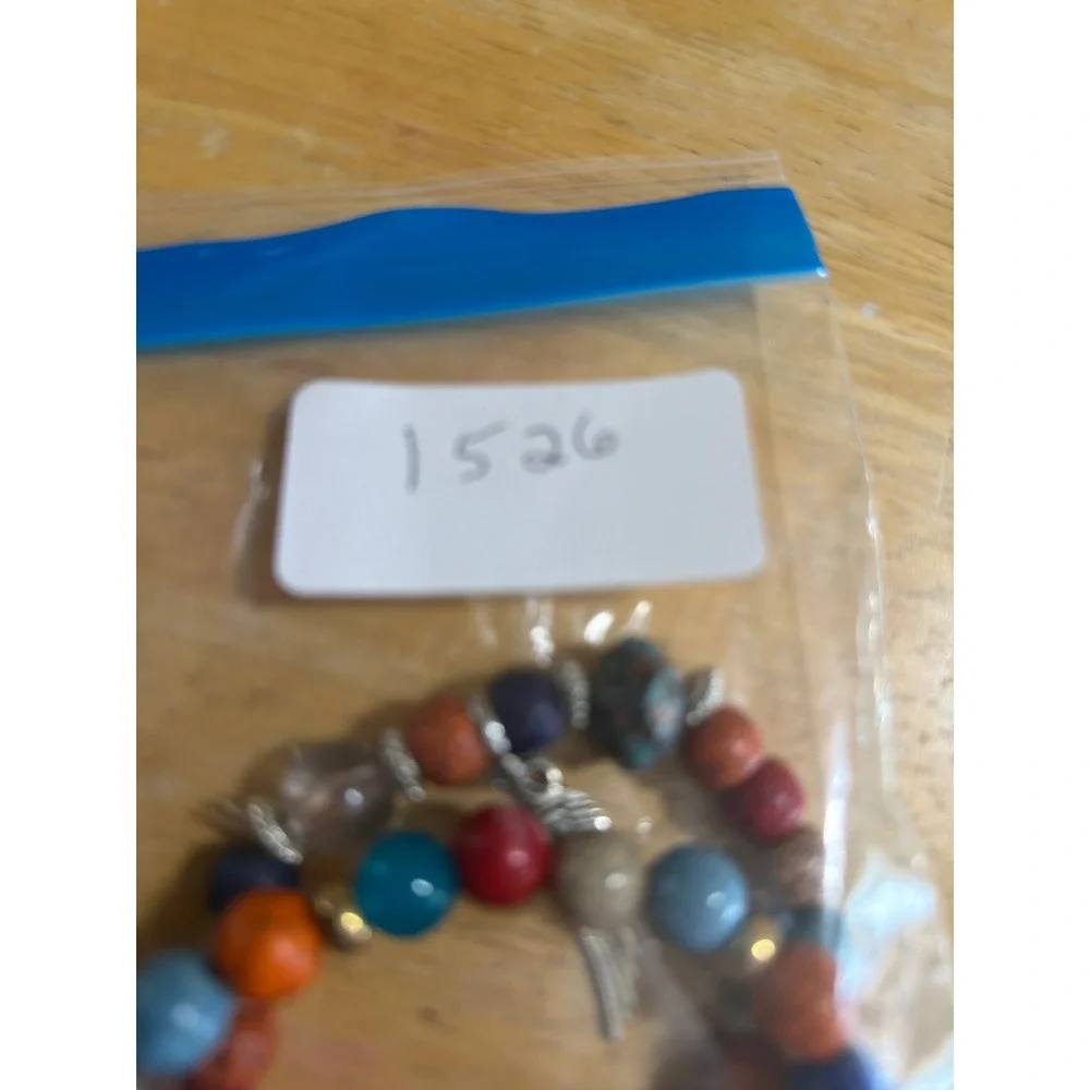 Set of 2 Multi Color Beaded Stretch Bracelets  Silver Wing Charm